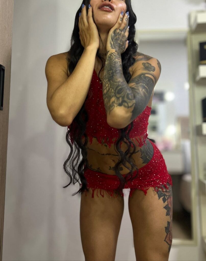 Pamela, a 24-year-old escort, poses with her hands on her cheeks on Mujeresconclase